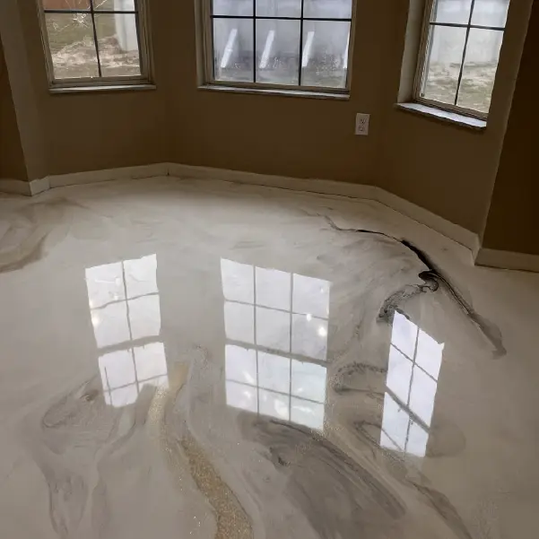 Metallic epoxy resin floor with marble effect finish installed by Ropez Resin in a residential space with bay windows in Central Florida.